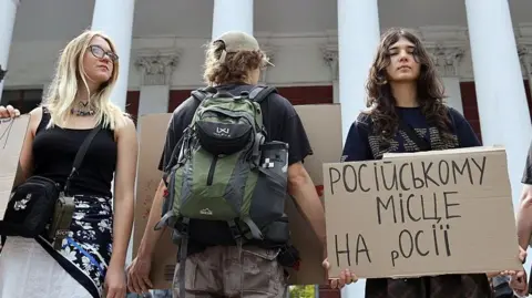 Global Images Ukraine via Getty Images Activists holding placards take part in a rally in support of introducing a moratorium on the public use of Russian-language cultural products on July 8, 2026 in Odesa, Ukraine