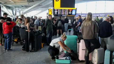 Reuters Groups of passengers wait in Heathrow T5 after disruption on Tuesday 8 September 