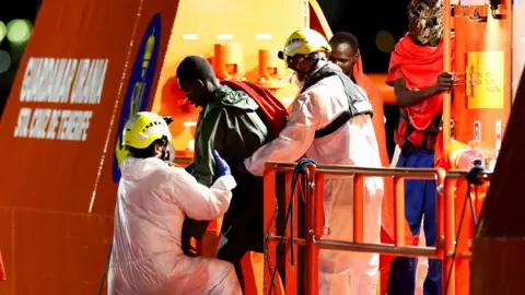 Reuters Migrants disembark vessel in Arguineguín, Gran Canaria, Spain, on 3 September