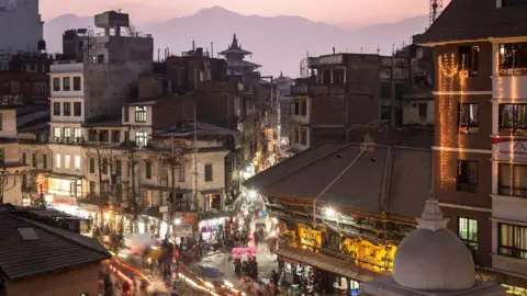 Didier Marti A buzzing hive of activity with shops and vehicles lit-up at an intersection in Kathmandu, the capital of Nepal