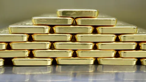 Reuters Gold bars are neatly stacked on top of each other to form a pyramid shape. 