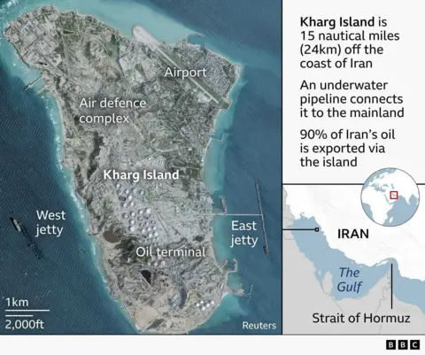 A graphic showing the location of Kharg Island in the northwest of The Gulf about 25 kilometres off the coast of Iran. A satellite image shows the wholkhe island which is roughly eight kilometres long and four kilometres wide. Shadows indicate that the island has many rocky outcrops but the island has been heavily industrialised. There is an airport in the northeast that extends slightly into the sea and around it appears to be the main accommodation on the island. The oil terminal takes up most of the southern half of the island where more than fifty large, white circular structures are clearly visible. These are the oil containers and they are surrounded by other smaller industrial buildings. The south of the island is flanked by two jetties for oil tankers to dock when loading. In the middle of the island an area is labelled as being an air defence complex. Image credit: Reuters, Google.
