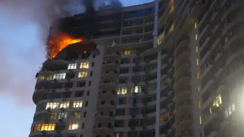 DSNS / Odesa region A fire burns at top floors of a multi-storey residential building in Odesa, southern Ukraine, following a Russian aerial attack. Photo: 12 September 2026.
