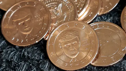 Reuters U.S. President Donald Trump's portrait on $1 coins, in honor of the nation's 250th anniversary of independence, on the day the coin is released for sale.