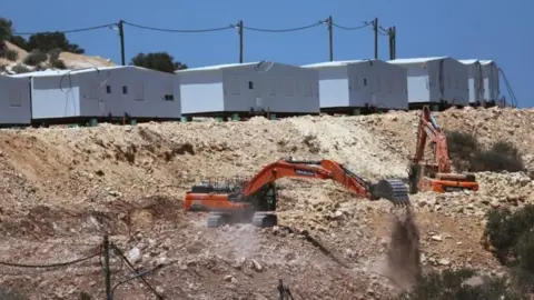 EPA Israeli bulldozers near a new settlement in the West Bank