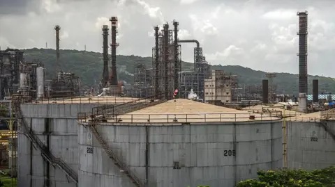 Getty Images Storage tanks at a Bharat Petroleum Corp. oil refinery in Mumbai, India. Photo: August 2025